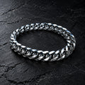 Polished curb-link bracelet on a charcoal cushion