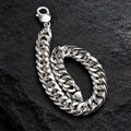 Polished flat curb-link chain with lobster clasp. On a charcoal background
