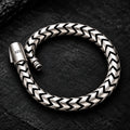 925 sterling silver bracelet with chevron links on a dark textured background