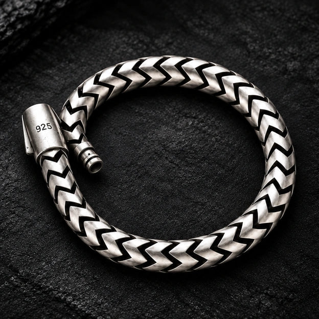 925 sterling silver bracelet with chevron links on a dark textured background