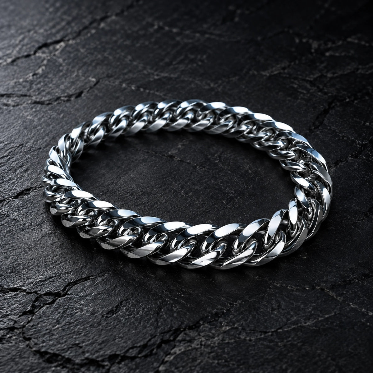 Polished curb-link bracelet on a charcoal cushion