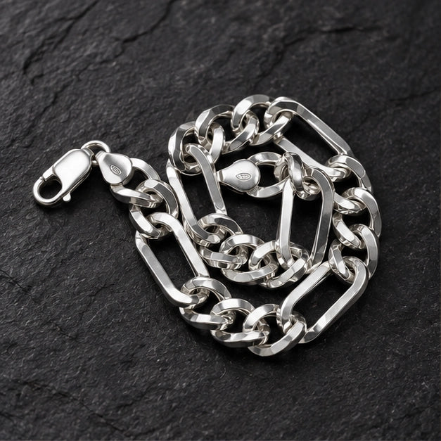 Polished alternating elongated rectangular links and shorter rounded curb links, lobster clasp. On a charcoal background