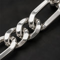 Polished alternating elongated rectangular links and shorter rounded curb links, lobster clasp. Macro view of visible bracelet details