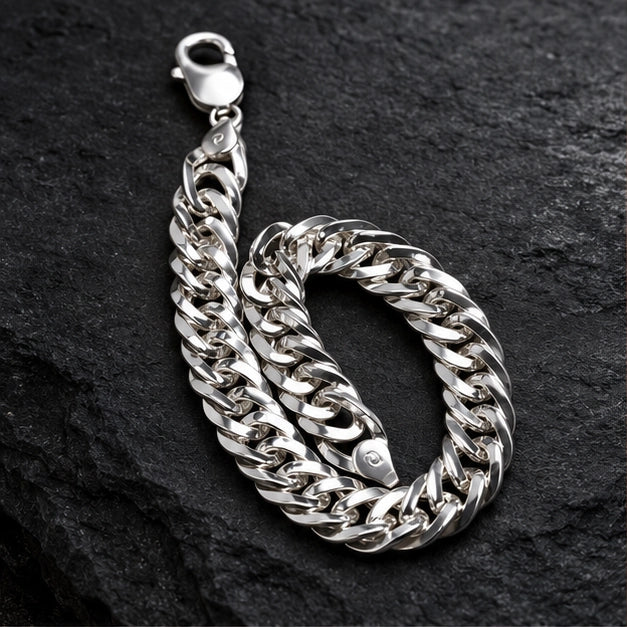 Polished flat curb-link chain with lobster clasp. On a charcoal background