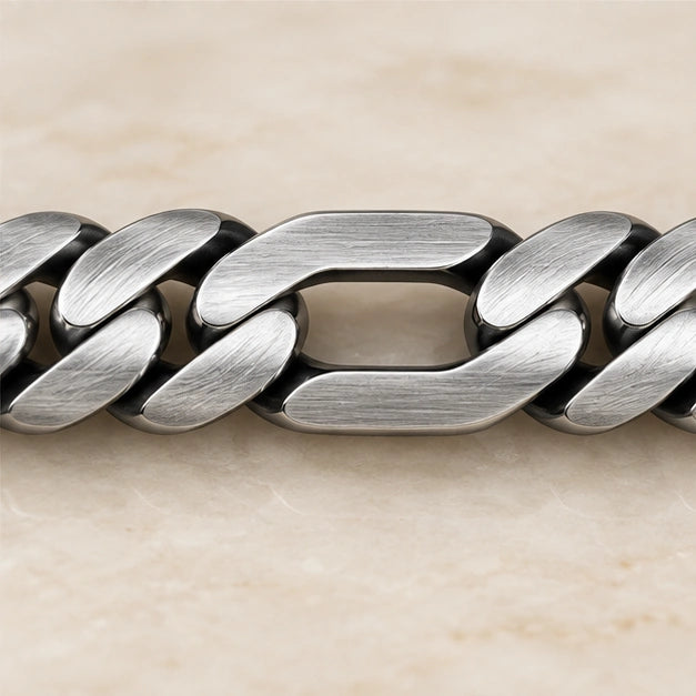 Flat alternating curb and elongated link bracelet in a close-up of visible links